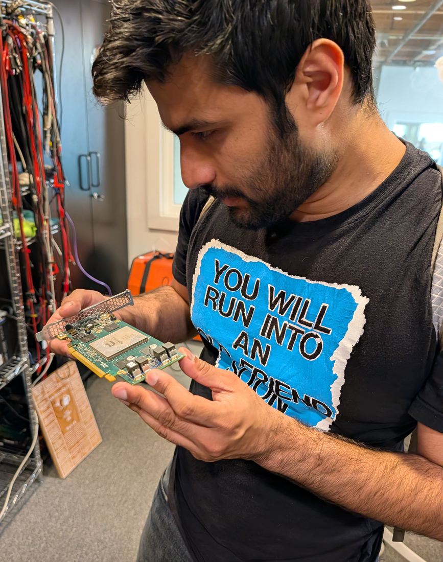 Daanish looks closely at a bare ET-SoC-1 card held in both hands